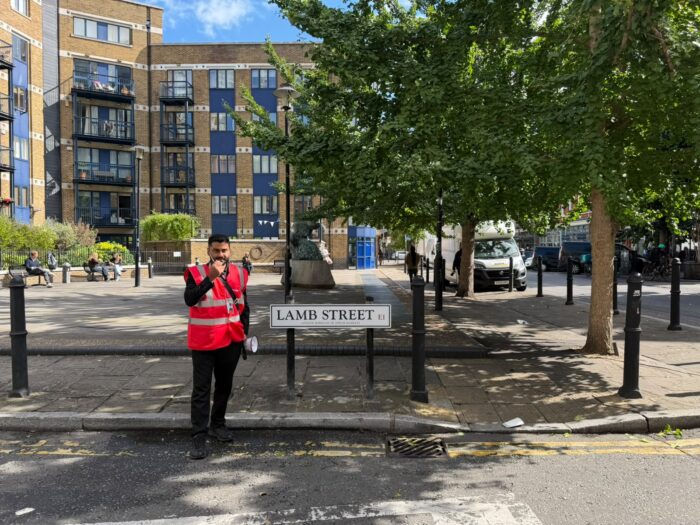 Ashridge waking watch officer on patrol at Lamb Street, Spitalfields, in the London Borough of Tower Hamlets
